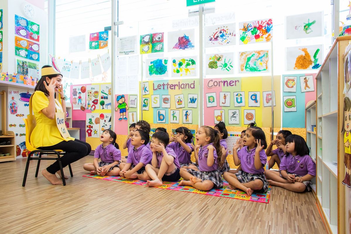 Children enjoying a phonics activity in the Letterland classroom corner